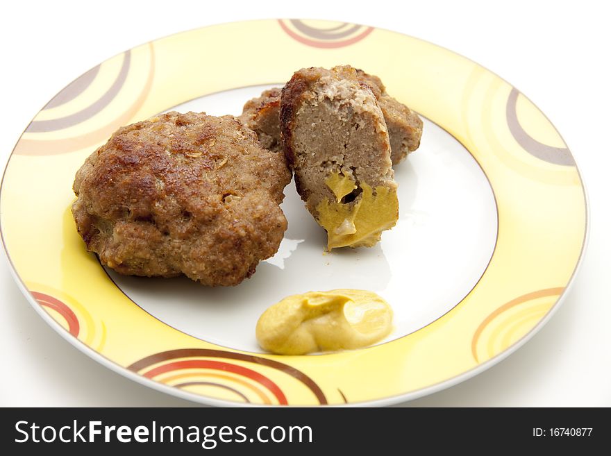 Rissole roasted with mustard and onto plates