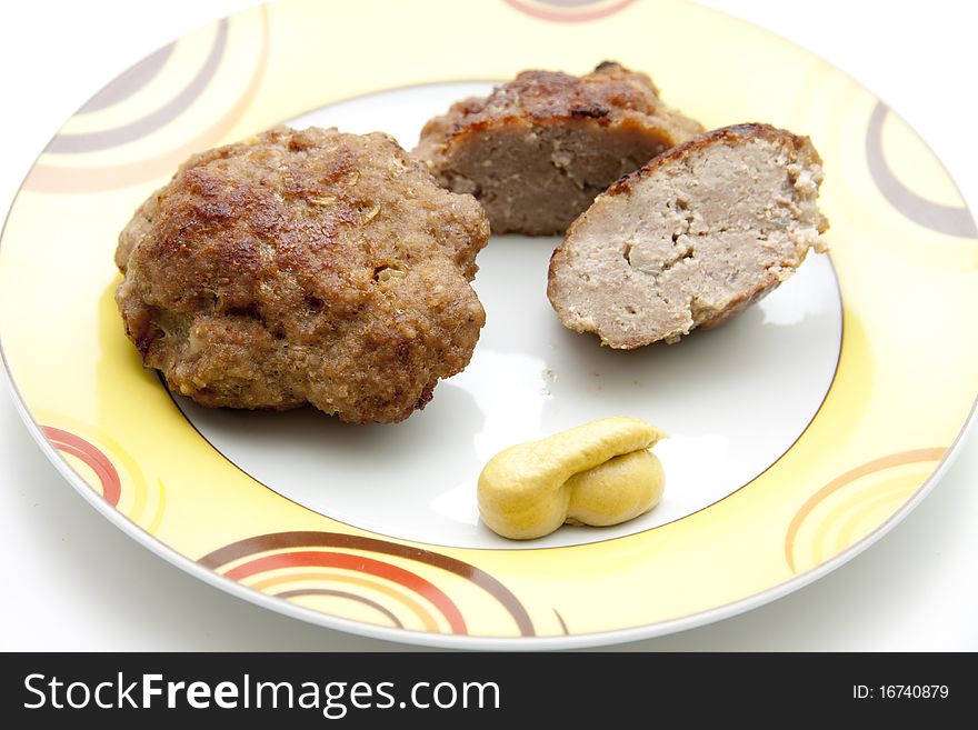 Rissole roasted with mustard and onto plates