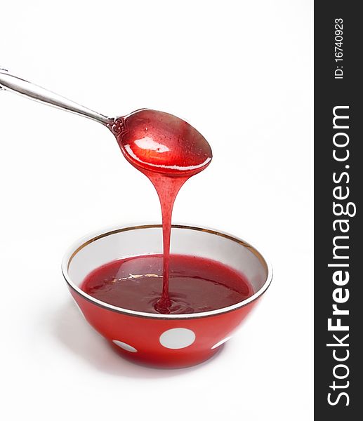 Berry jam in a red saucer (isolated on a white)