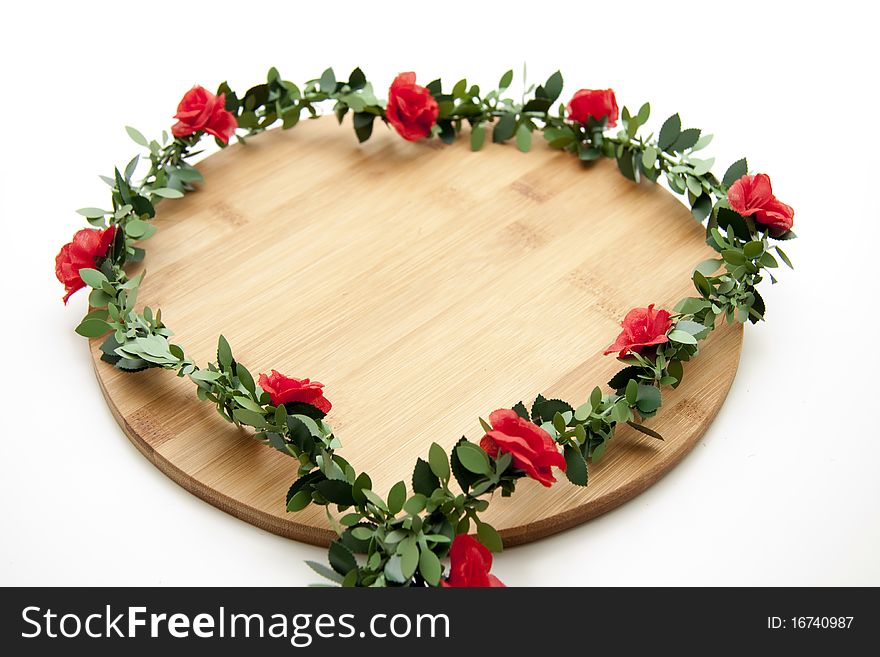 Wreath with roses on wood board
