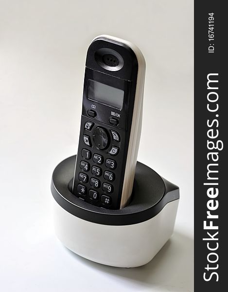Isolated of old style remote control phone,with charger.