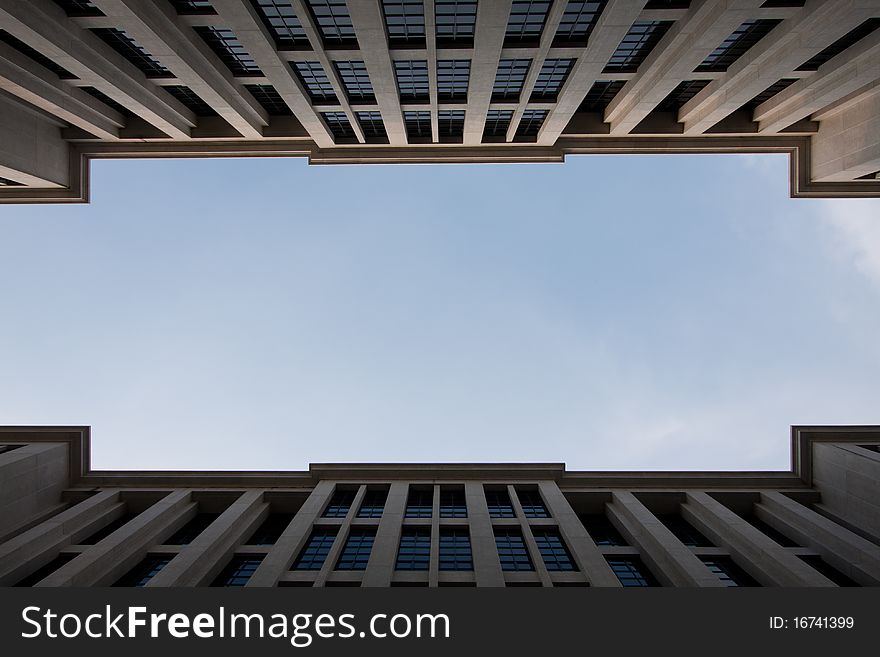 Sky between tall buildings. One corner between two buildings spaced tall buildings to clear skies. Sky between tall buildings. One corner between two buildings spaced tall buildings to clear skies.