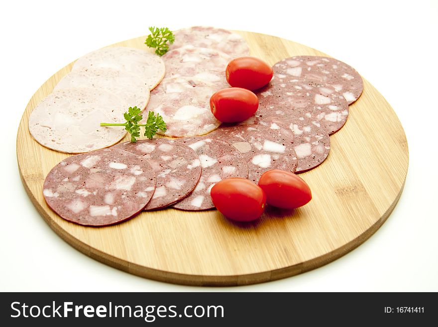 Sausage plate with cherry tomatoes and parsley. Sausage plate with cherry tomatoes and parsley