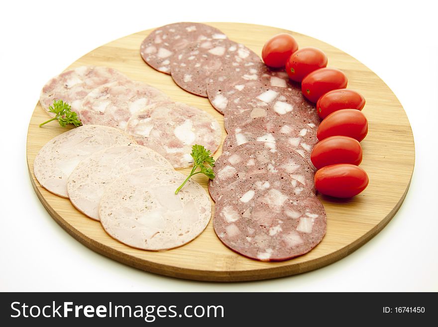 Sausage plate with cherry tomatoes and parsley. Sausage plate with cherry tomatoes and parsley