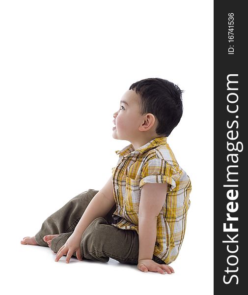 Cute boy sitting and looking to the side, isolate on white background. Cute boy sitting and looking to the side, isolate on white background