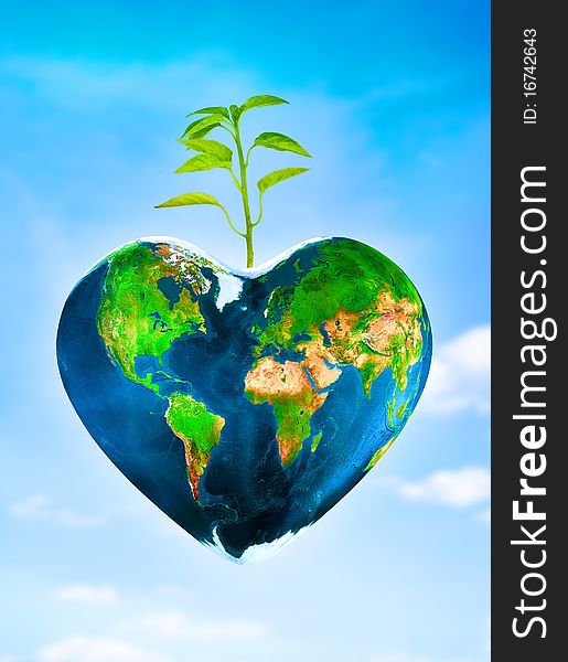 Earth in a shape of a heart with a young plant. Earth in a shape of a heart with a young plant