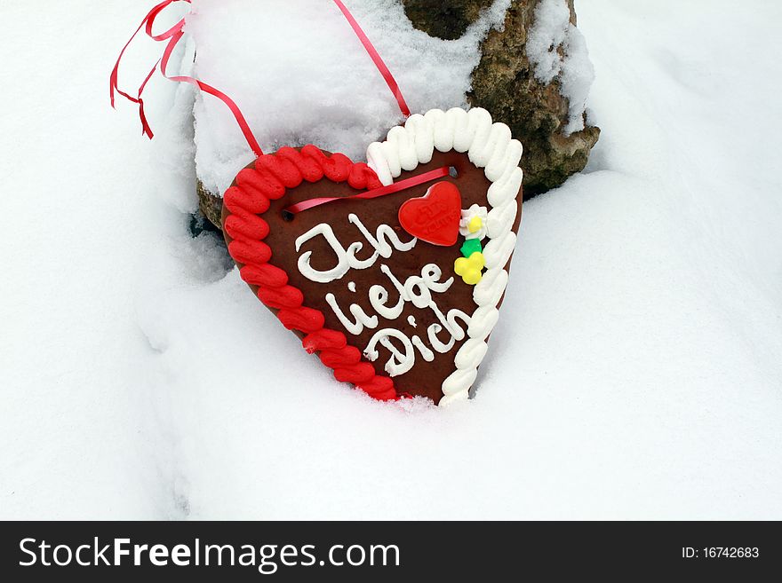 Gingerbread heart in the snow. Gingerbread heart in the snow