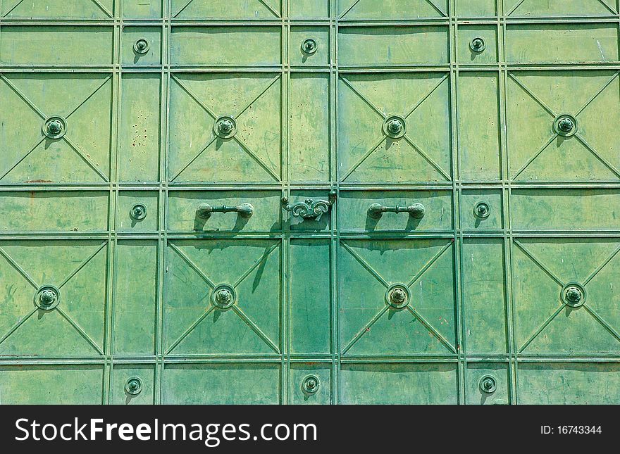 Green rusty metal door detail.