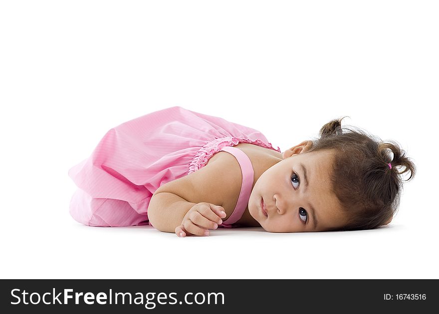 Cute little girl laying down on the floor, isolated on white background