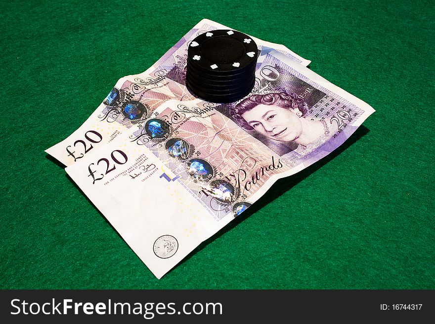 Two English twenty pound notes photographed on a poker table with poker chips. Two English twenty pound notes photographed on a poker table with poker chips