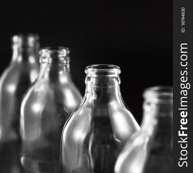 Empty bottles collection, colorless, isolated on black background