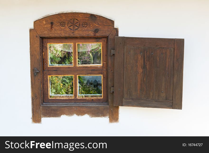 Wooden fretted brown window of old house. Wooden fretted brown window of old house