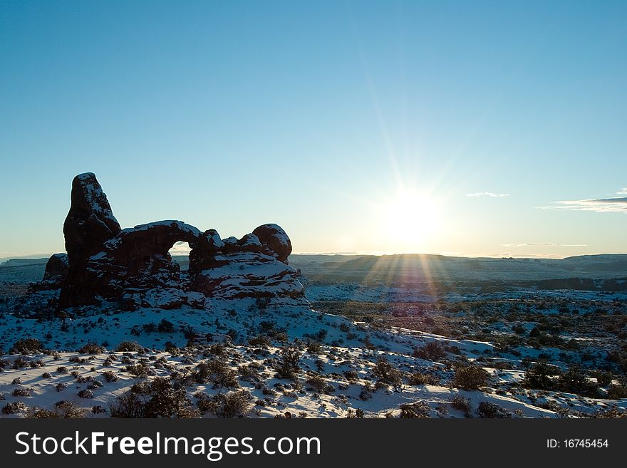 Sun over Turret Arch in Arches National Park