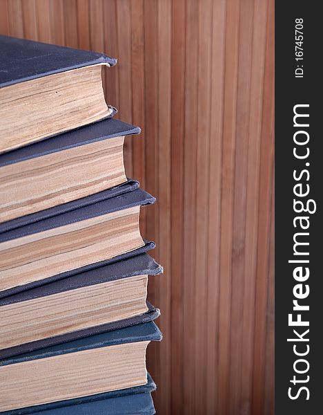 Tower of books with wooden background