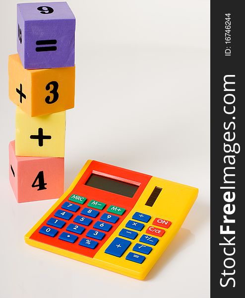 A vertical of a calculator and stacking numbered building blocks. A vertical of a calculator and stacking numbered building blocks