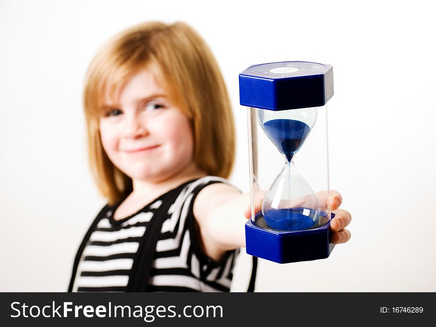 A horizontal image of a girl holding up a hourglass. A horizontal image of a girl holding up a hourglass