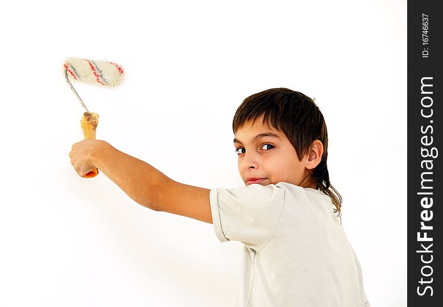 Teenage caucasian boy painting white wall indoor. Teenage caucasian boy painting white wall indoor