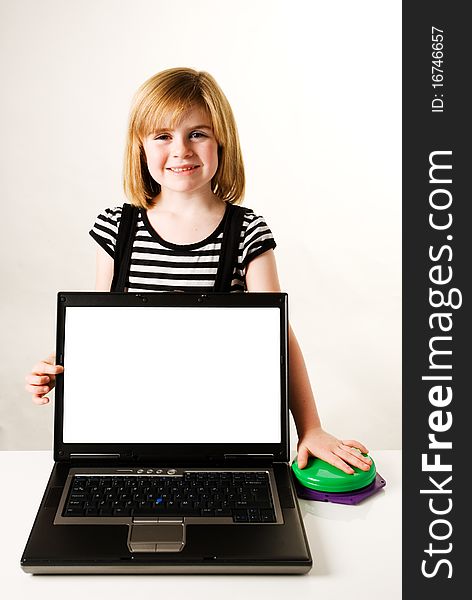 A vertical image of a young girl with a laptop with a blank screen for copy and green switch for green for go concept. A vertical image of a young girl with a laptop with a blank screen for copy and green switch for green for go concept