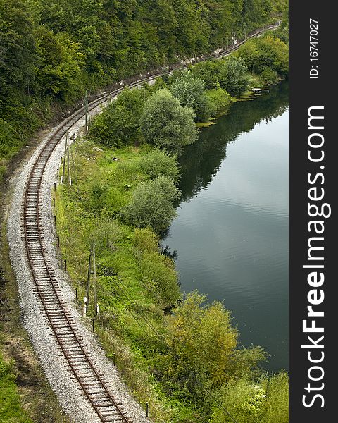 Railroad curve and river with trees. Railroad curve and river with trees