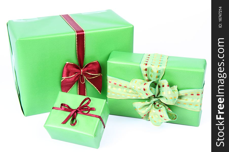 Gifts in green wrapping with bows on white background