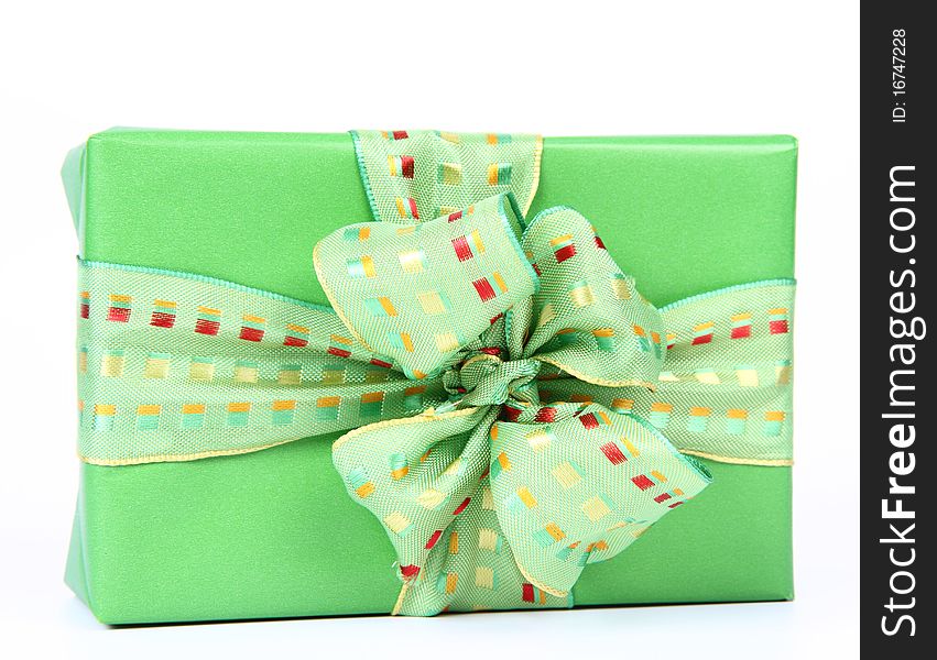 Gift in green wrapping with a green bow on white background