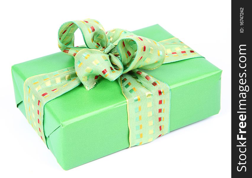 Gift in green wrapping with a green bow on white background