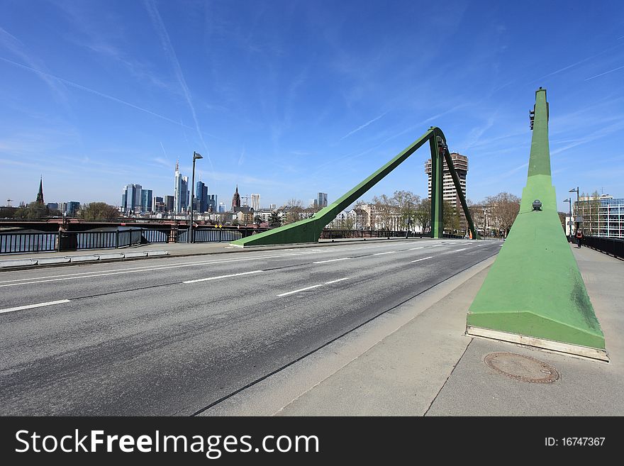 Flößerbrücke is a 221 meters long bridge over the Main river in Frankfurt am Main, Germany.In the background can be seen the skyline of Frankfurt. Flößerbrücke is a 221 meters long bridge over the Main river in Frankfurt am Main, Germany.In the background can be seen the skyline of Frankfurt.