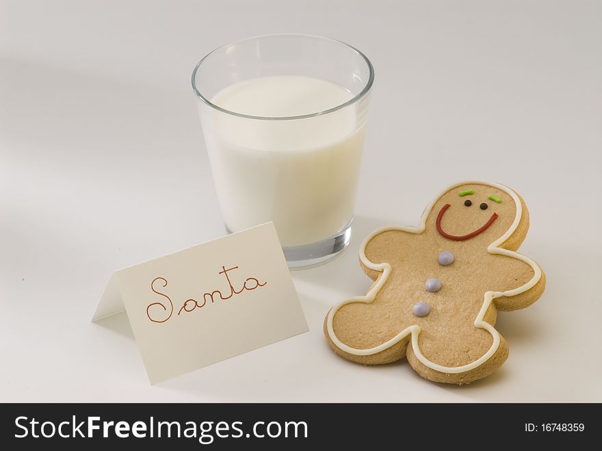 Traditional Christmas gingerbread man cookie and a glass of milk for Santa. Traditional Christmas gingerbread man cookie and a glass of milk for Santa