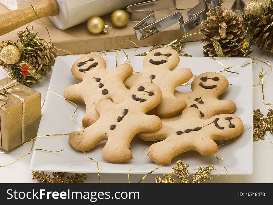 Traditional Christmas gingerbread man cookies in a white plate. Traditional Christmas gingerbread man cookies in a white plate.