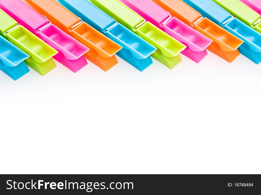 Close up shot of multicolored clothespins isolated on white