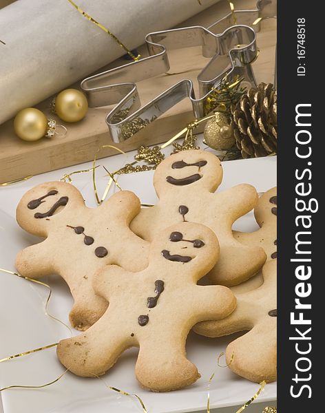 Traditional Christmas gingerbread man cookies in a white plate. Traditional Christmas gingerbread man cookies in a white plate.