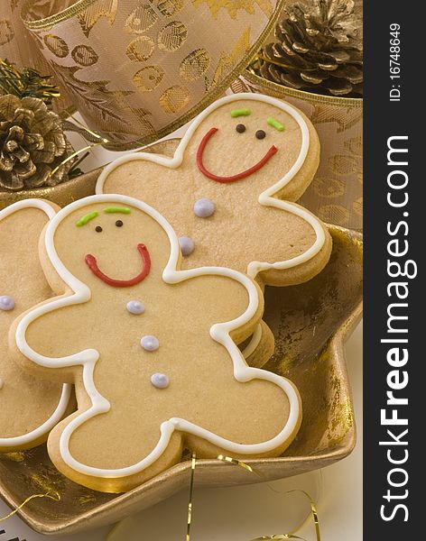 Traditional Christmas gingerbread man cookies in a golden plate. Traditional Christmas gingerbread man cookies in a golden plate.
