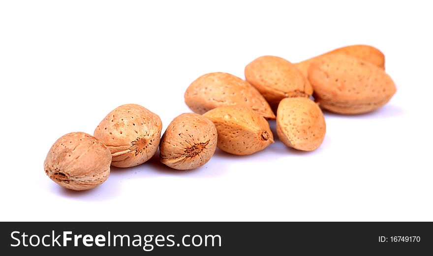 Almonds with shell isolated on white background.