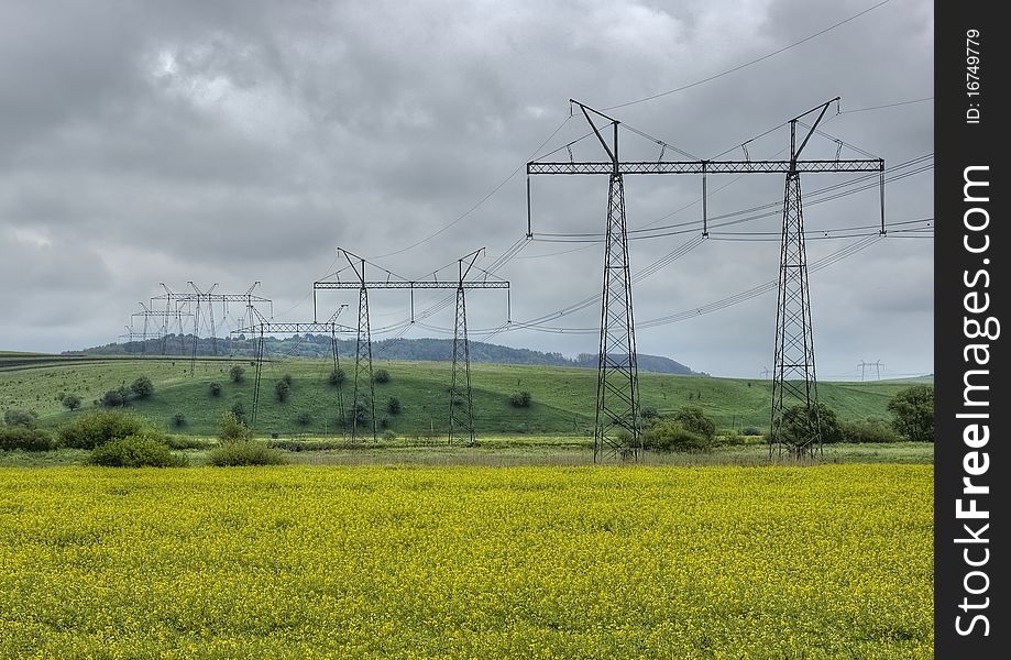 High-voltage power line in a field of