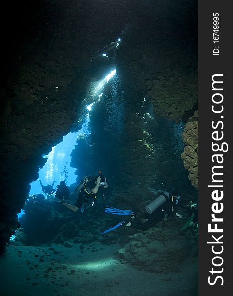 Scuba divers exploring an underwater cave.