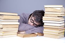 The Young Tired Student With The Books Isolated. Royalty Free Stock Photos The Young Tired Student With The Books Isolated. Royalty Free Stock Photos