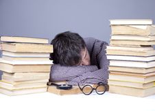 The Young Tired Student With The Books Isolated. Royalty Free Stock Photography The Young Tired Student With The Books Isolated. Royalty Free Stock Photography