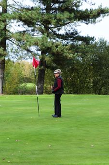 Female Golfer Standing Next To Putting Flag Stock Photos Female Golfer Standing Next To Putting Flag Stock Photos