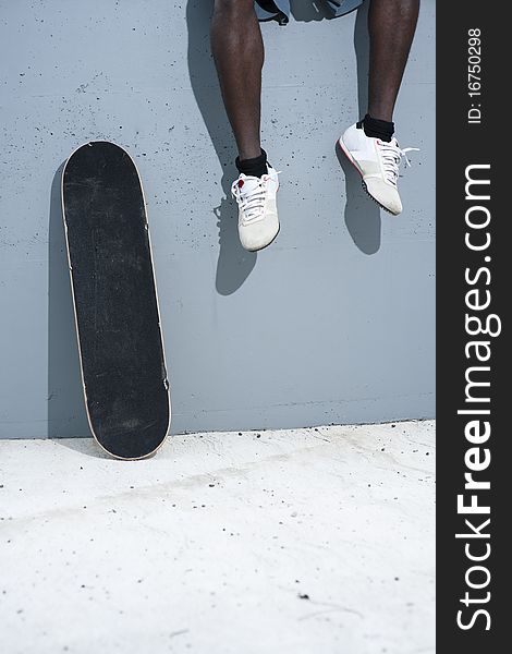 Skateboarder on wall and human legs