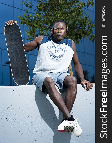 Young skateboarder taking a rest