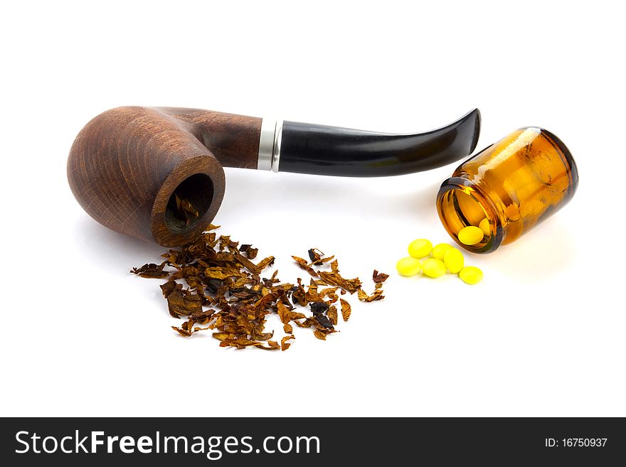Tobacco pipe and Pills on white background