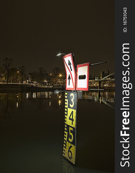 Night shot of tide sign on the river Maas in the Netherlands
