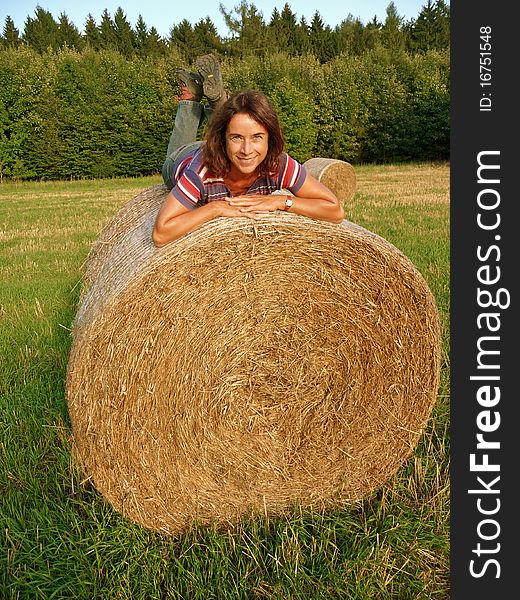 Happy Woman on Straw Bale