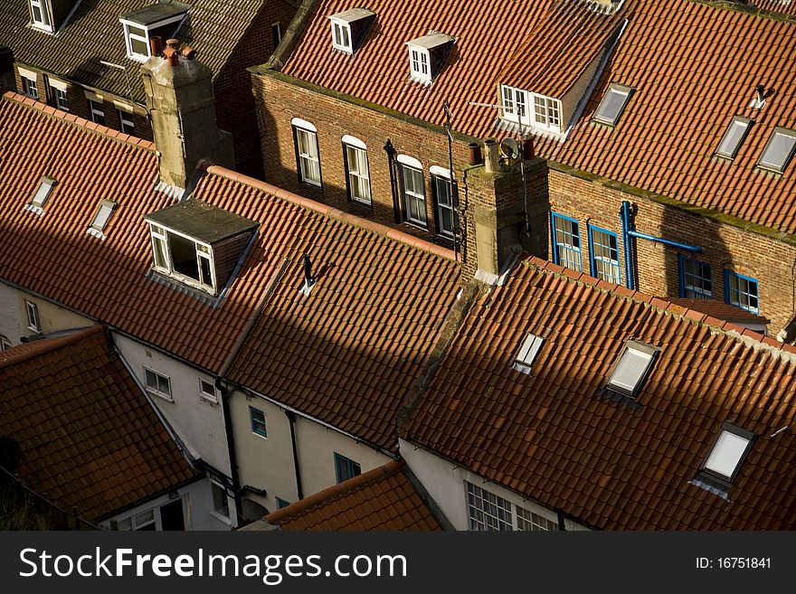 Overhead view of a row of red roofed cottages at the lovely resort of Whitby. Overhead view of a row of red roofed cottages at the lovely resort of Whitby