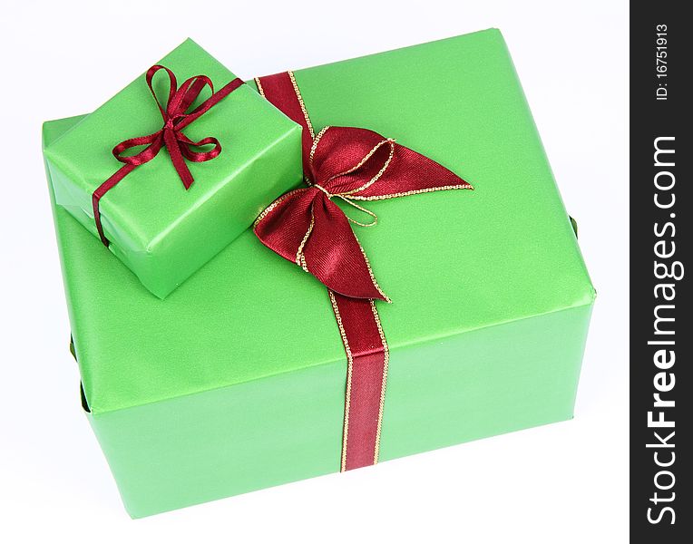 Gifts in green wrapping with red bows on white background