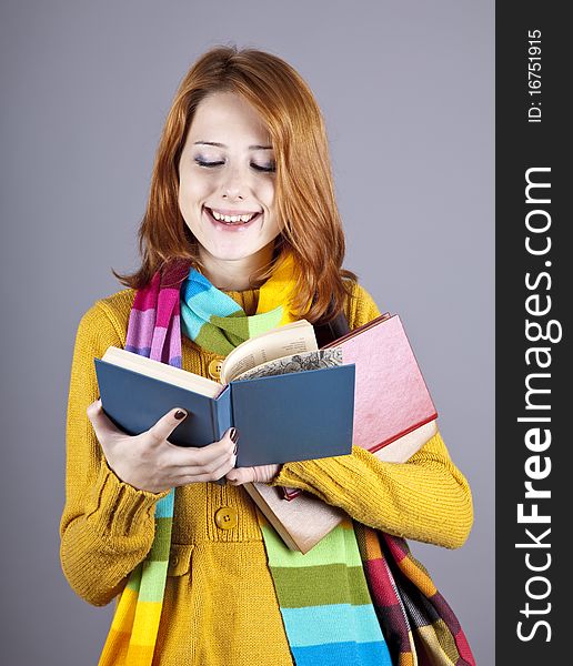 Young student girl with books. Studio shot.