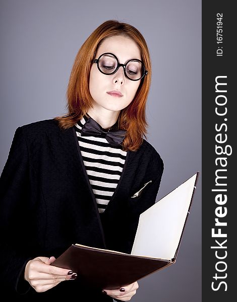 Portrait of beautiful and style red-haired girl with folder. Portrait of beautiful and style red-haired girl with folder.