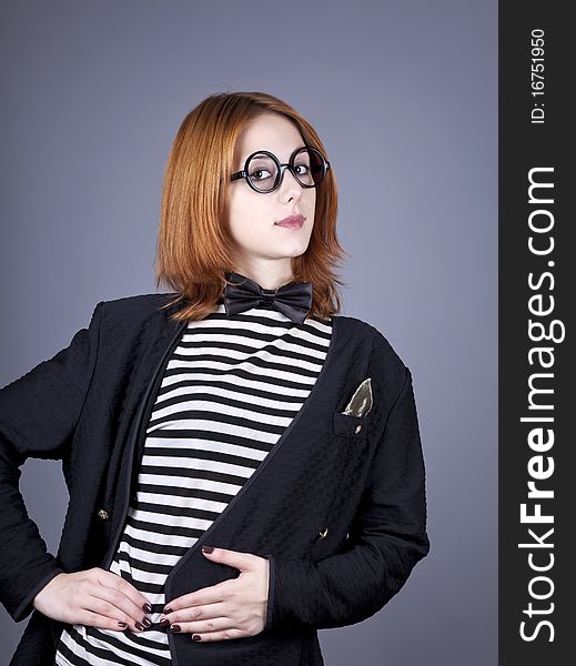 Portrait of beautiful and style red-haired girl. Studio shot.