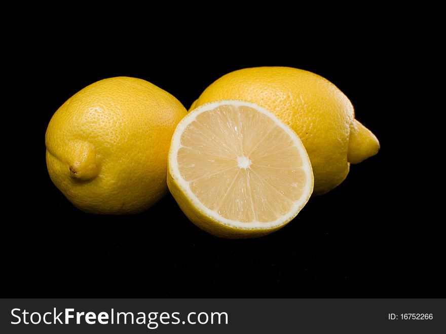On a black background lie lemons