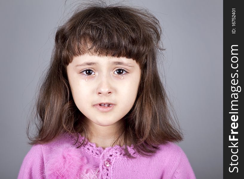 Young brunet girl cry. Studio shot.